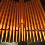 Polished organ pipes inside the church.