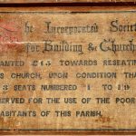 Historic plaque mounted on the church wall.