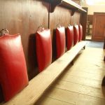 Row of red-cushioned wooden church seats.