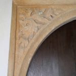Carved stone leaf decoration on an interior church arch.