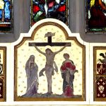 Painted church panel showing the crucifixion with figures standing beside the cross.