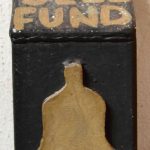 Old church bell fund box with painted lettering and coin slot.
