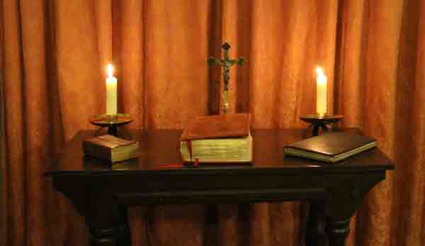 Church altar with cross, bible and candles